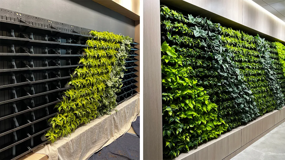 A lush tray-based living wall with multiple plant species arranged in stacked trays.